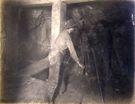 High ore 300 ft. level East Showing men and drilling machine on fourth floor drilling air on breast