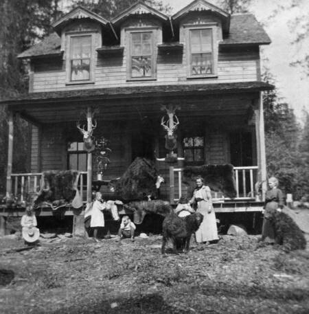 Gwen, Dorothy, Mrs. Bovill, and others standing in front of a new house at Warren Meadows.