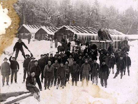 Loggers and living quarters at Hunicker Logging Camp. Near Elk River, Idaho.