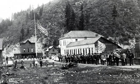 View of 4th of July parade looking north on 7th Street toward fire station. Wallace, Idaho.