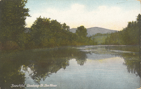 Postcard of the St. Joe River in Idaho. | The St. Joe River is navigable a distance of 40 miles from Lake Coeur d'Alene to St. Joe. For perfect reflections and shadow scenery this river is unsurpassed. Daily excursions to St. Joe River via C. d'A. & S. electric line and Red Collar steamers.